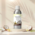 Veena Coco Vanilla Premium Vaporizer and Diffuser Oil 100ml aluminum bottle displayed on a cream display base surrounded by sliced raw coconuts and vanilla beans.