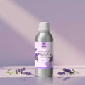 Veena Lavender Premium Vaporizer and Diffuser Oil 100ml bottle sitting on a purple display step with fresh lavender sprigs around it.