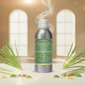 Veena Lemon Grass Vaporizer and Diffuser Oil 100ml bottle showcased with fresh lemongrass stalks in a brightly lit room.