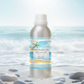Veena Ocean Breeze Vaporizer and Diffuser Oil 100ml bottle set against a beautiful beach shoreline background with ocean waves.