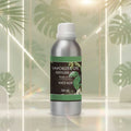 Veena White Musk Vaporizer and Diffuser Oil 100ml bottle with a crisp, bright architectural setting and elegant green leaves in the background.