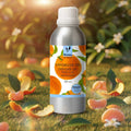 Veena Mandarin Premium Vaporizer and Diffuser Oil 100ml canister resting inside a green grass field covered with fallen mandarin orange peels under daylight.