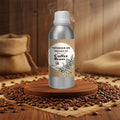 Veena Coffee Beans Vaporizer and Diffuser Oil 100ml bottle standing on a wooden pedestal surrounded by fresh scattered coffee beans.