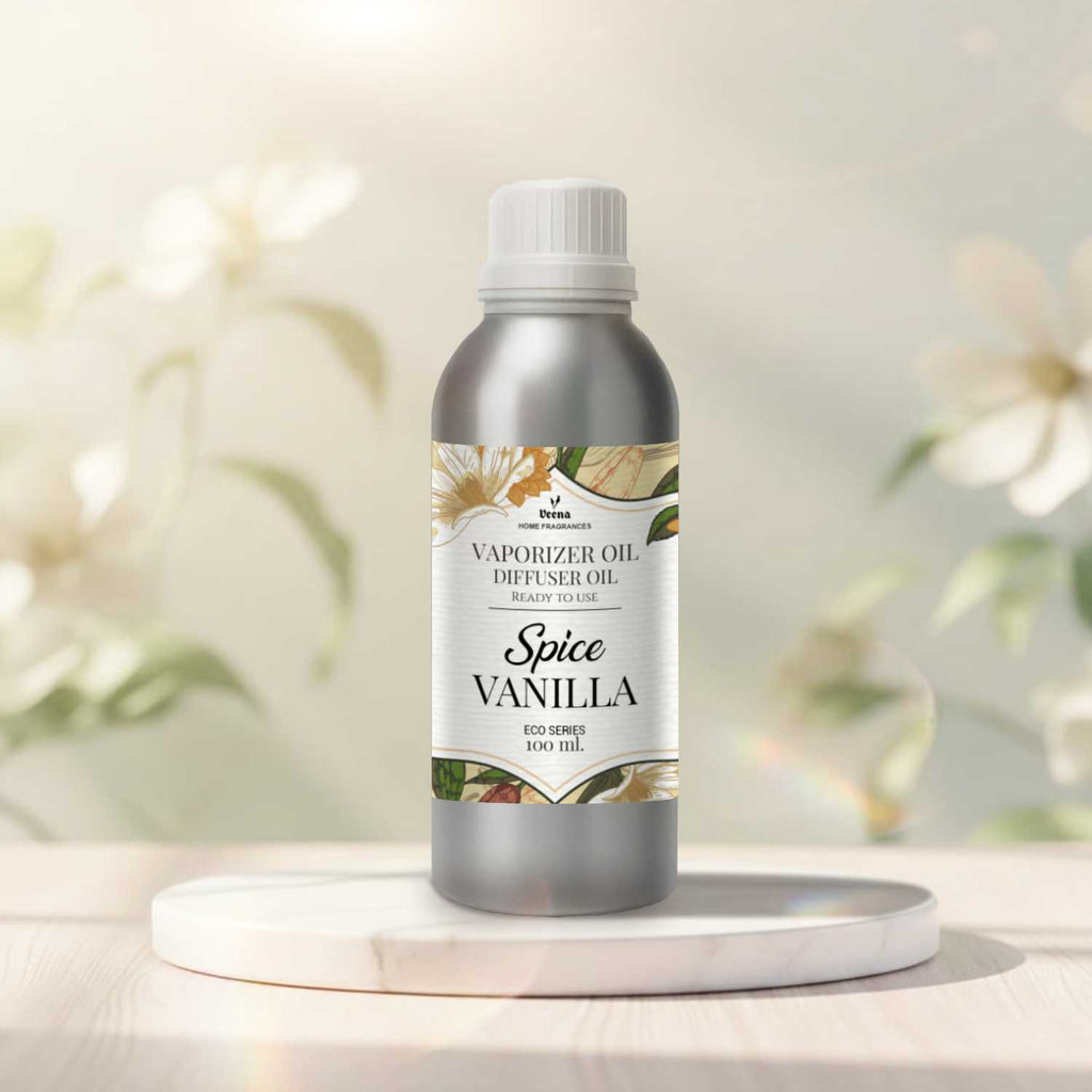 Veena Spice Vanilla Premium Vaporizer and Diffuser Oil 100ml bottle standing on a polished white marble step with a soft blurred floral backdrop.