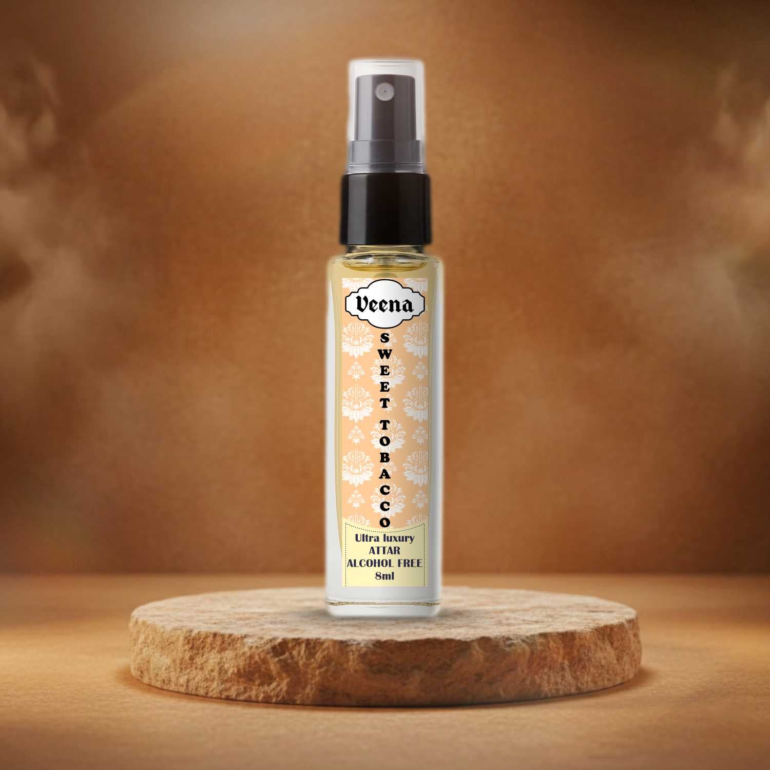 Veena Sweet Tobacco original 100% alcohol-free 8ml perfume spray bottle presented beautifully on a rough-cut natural sand stone slice podium with warm amber background styling.