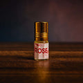 Veena luxury non-alcoholic Rose Gulab perfume oil bottle highlighted on a rich dark textured studio surface.