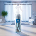 Veena Fresh Breeze premium room freshener spray bottle displayed on a minimalist table with a bright, airy living room layout background.