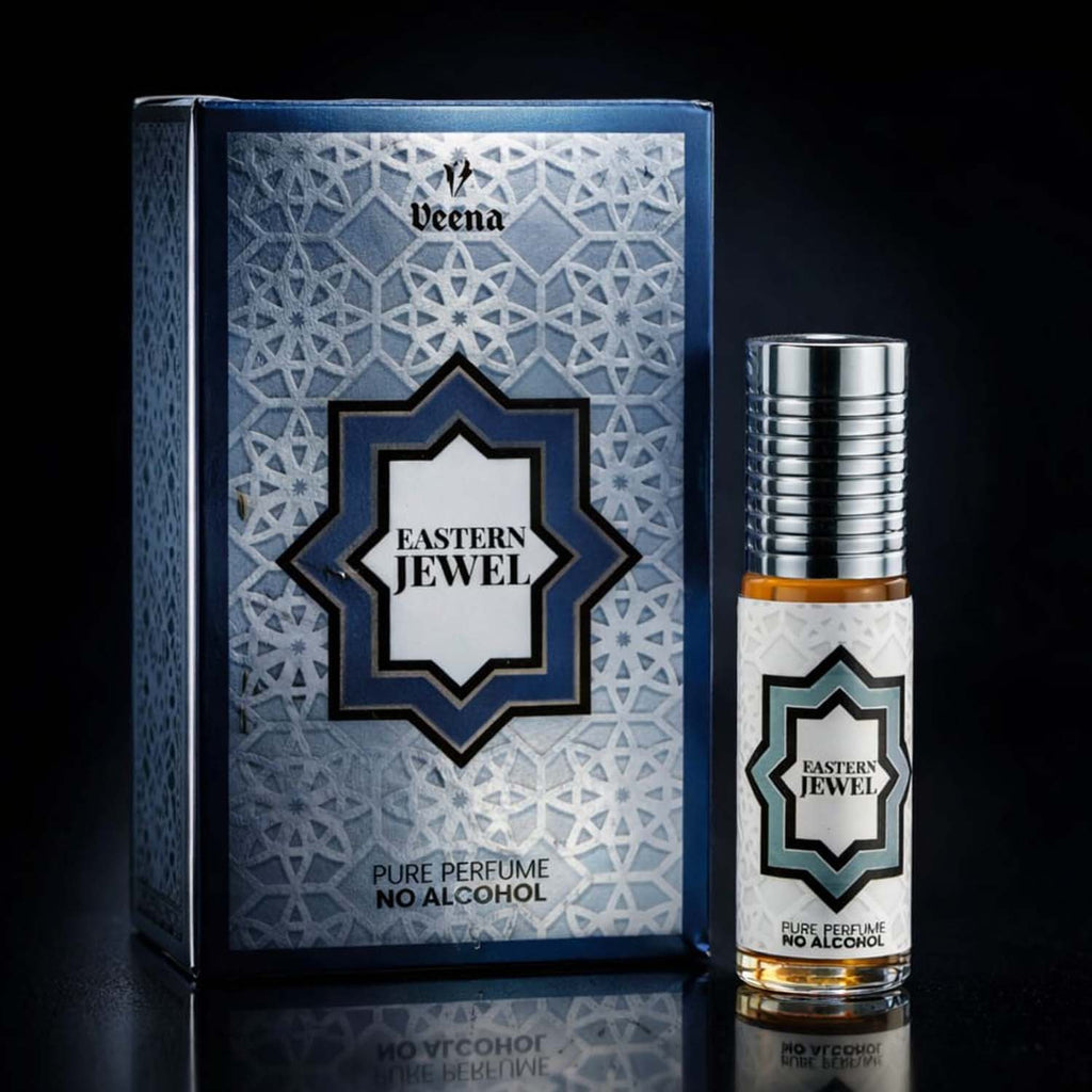 Veena luxury Eastern Jewel perfume oil pocket roll-on standing next to its premium midnight blue and silver geometric star presentation box.