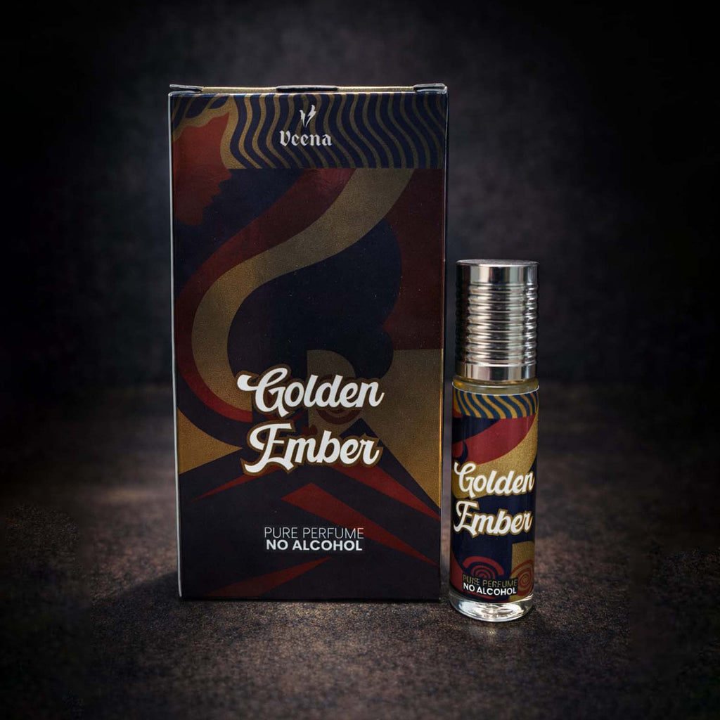 Veena luxury Golden Ember perfume oil pocket roll-on standing next to its premium silver, maroon, and gold artistic presentation box.