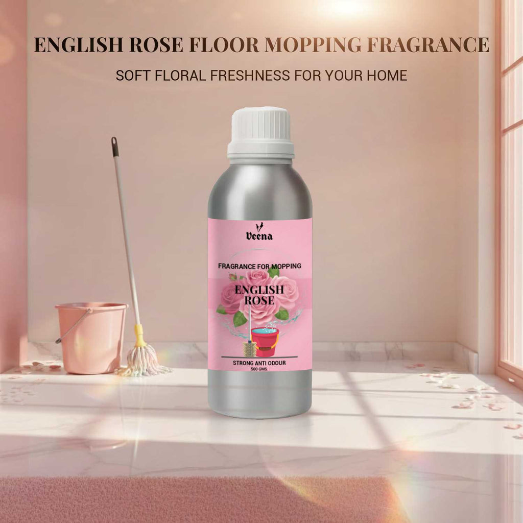 Veena English Rose Floor Mopping Fragrance 500g aluminum bottle displayed with a pink mop and bucket inside a clean tiled bathroom setting.