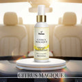 Veena Citrus Magique Premium Car Air Freshner Mist 100ml bottle displayed on a white podium inside a luxury car with bright beige leather seats.