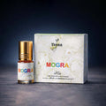 Veena Mogra premium apparel attar concentrate bottle standing next to its luxury white floral presentation gift box.