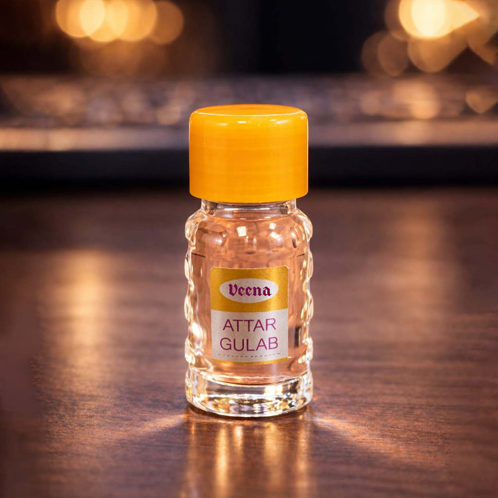 Veena Attar Gulab authentic rose perfume oil travel-sized vial showcasing its clear pink floral color.
