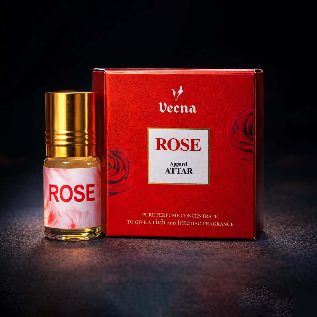 Veena Rose premium apparel attar concentrate bottle standing next to its luxury crimson red presentation gift box.