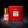 Veena Rose premium apparel attar concentrate bottle standing next to its luxury crimson red presentation gift box.