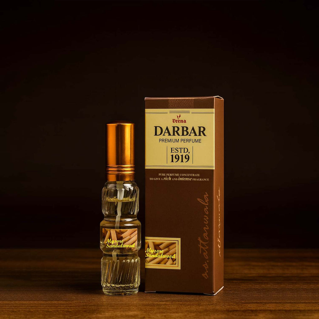 Veena Darbar Mysore Sandalwood perfume bottle standing next to its heritage brown outer packaging box