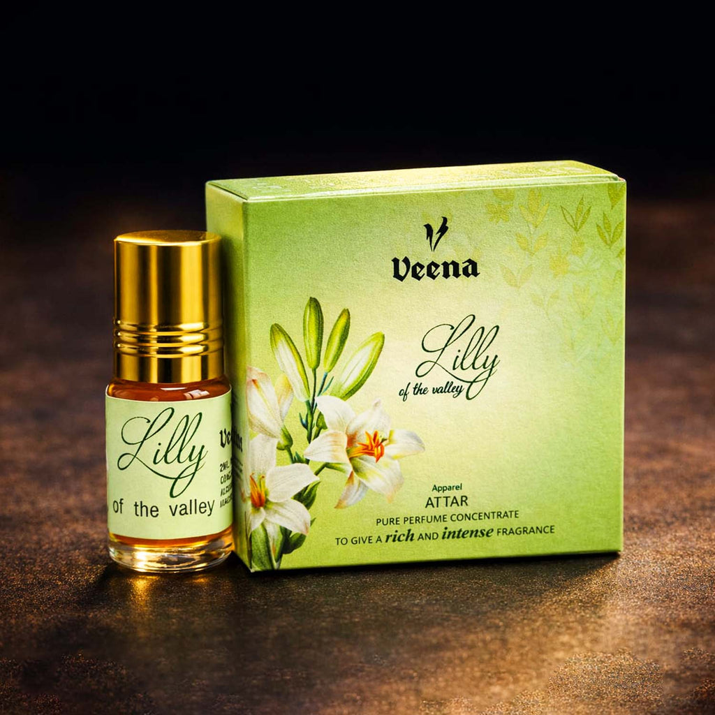 Veena Lilly of the Valley premium apparel attar concentrate bottle standing next to its luxury green floral presentation gift box.