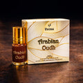 Veena Arabian Oudh premium apparel attar concentrate bottle standing next to its luxury cream and gold golden-wave presentation gift box.
