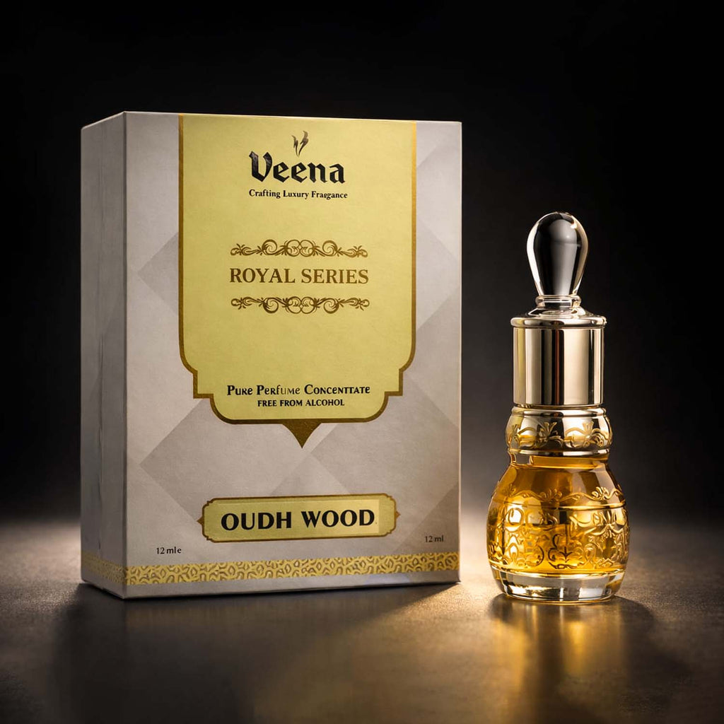Veena Oudh Wood luxury non-alcoholic perfume oil decanter standing elegantly next to its gold and gray presentation box.