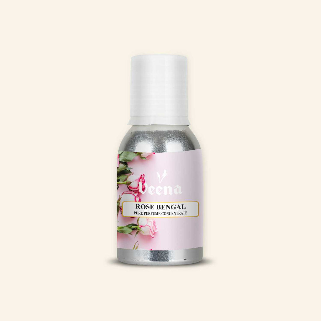Veena Rose Bengal Pure Perfume Concentrate aluminum bottle with a soft pink background featuring fresh white and pink-edged rose buds label design.