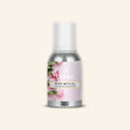 Veena Rose Bengal Pure Perfume Concentrate aluminum bottle with a soft pink background featuring fresh white and pink-edged rose buds label design.