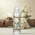veena Premium Attar Jasmine 100ml miniature glass bottle standing on luxury white marble slab surrounded by fresh white blossoms