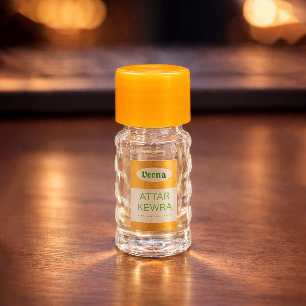 Veena Attar Kewra premium concentrated perfume oil bottle highlighted on a warm wooden studio surface with golden bokeh lights.