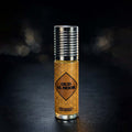 Veena Oud Al Noor premium non-alcoholic perfume oil roll-on bottle with a golden geometric mosaic print label and ribbed silver cap against a dark bokeh background.