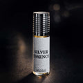 Veena Silver Essence premium non-alcoholic perfume oil roll-on bottle with a textured white leather grip and ribbed silver cap resting against a dark bokeh background.