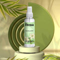 Veena Rajnigandha alcohol-free attar spray 100ml bottle on a premium green luxury display podium.