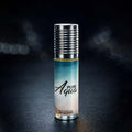 Veena Pure Aqua premium non-alcoholic perfume oil roll-on bottle with a textured silver cap resting against a dark bokeh background.