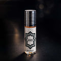 Veena Eastern Jewel premium non-alcoholic perfume oil roll-on bottle with a white and silver Arabesque geometric star label against a dark bokeh background.