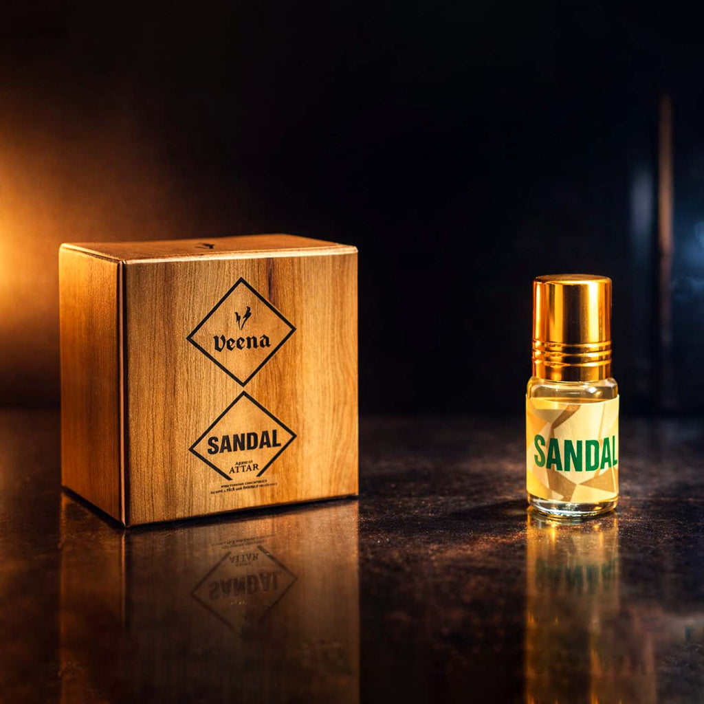 Veena Sandal premium apparel attar concentrate bottle standing next to its luxury wood-grain textured presentation gift box.