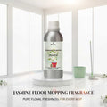 Veena Jasmine Floor Mopping Fragrance 500g aluminum bottle placed on a marble step with a white floor mop and bucket.
