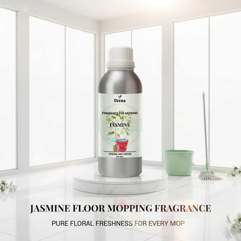 Veena Jasmine Floor Mopping Fragrance 500g aluminum bottle placed on a marble step with a white floor mop and bucket.