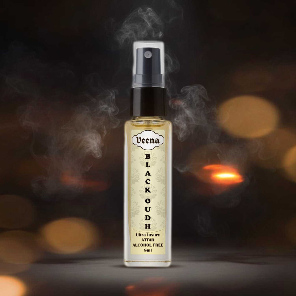 Veena Black Oudh intense dark agarwood perfume spray bottle standing dramatically amid swirling grey smoke plumes.