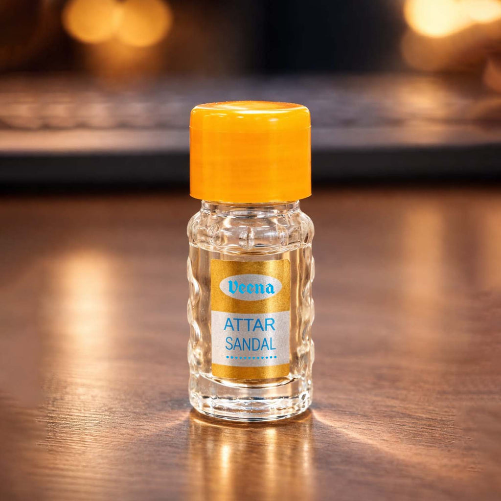 Veena Attar Sandal pure chandan concentrated perfume oil bottle resting under elegant golden studio lighting effects.