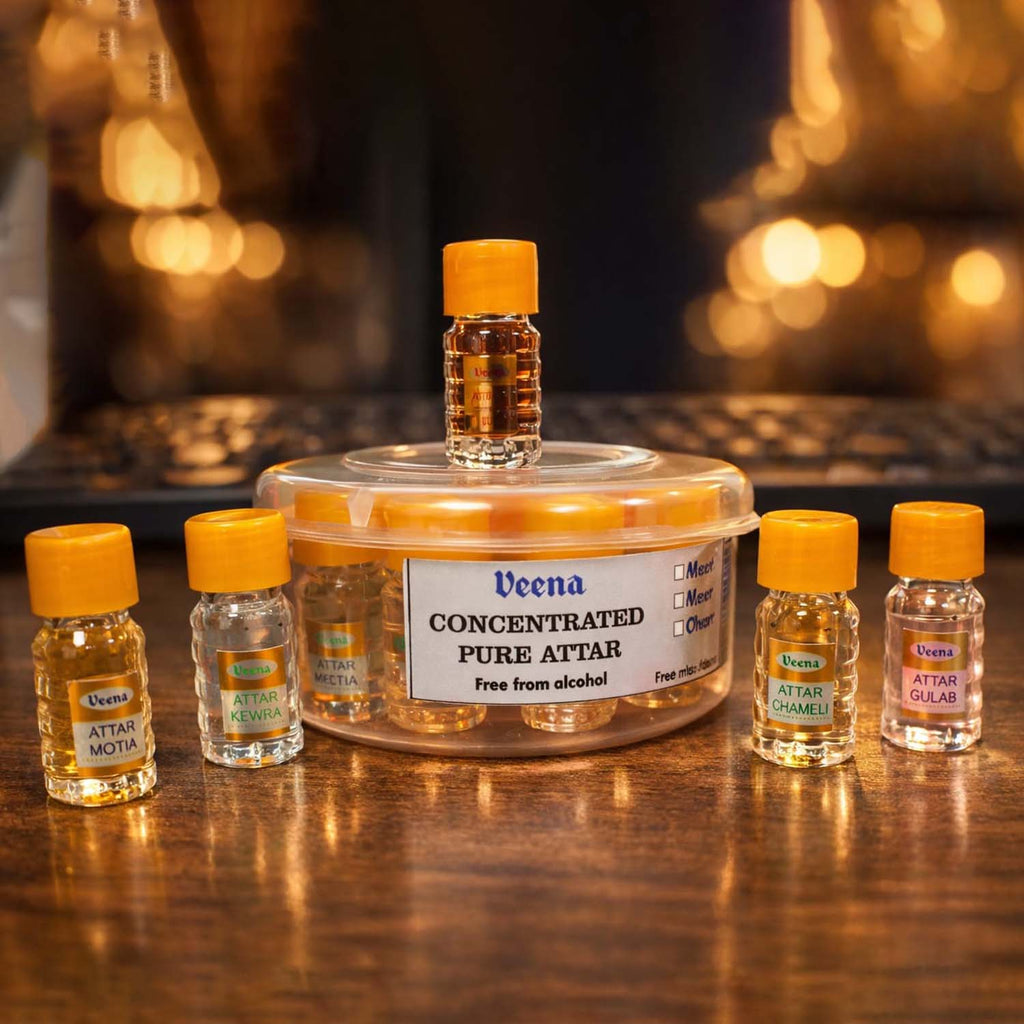 Veena Concentrated Pure Attar discovery set featuring five clear perfume oil vials with yellow caps around a circular travel case.