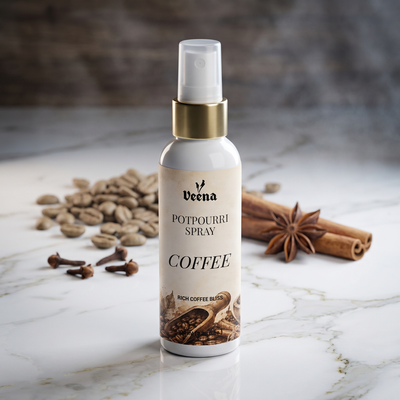 Veena Coffee Potpourri Spray 100ml bottle displayed on a white marble surface with raw coffee beans, cinnamon sticks, and star anise in the background – Rich Coffee Bliss Home Fragrance.