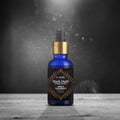 St. Thomas Black Oudh Oudh Negro Aroma Oil 15ml bottle on a rustic wooden table with an elegant dark studio background and dramatic lighting effects.