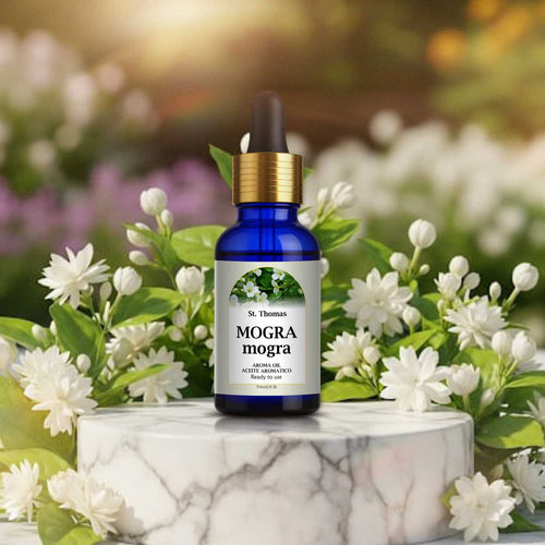 St. Thomas Mogra Aroma Oil 15ml bottle on a premium marble display stand enveloped by fresh blooming white jasmine mogra flowers.