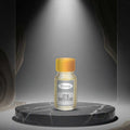 Veena Premium Attar White Oudh 2ml miniature glass bottle under elegant grey studio spotlight
