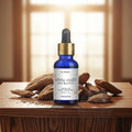 St. Thomas White Oudh Premium Aroma Oil 15ml bottle on a luxury wooden table with oud pieces and almonds, premium home fragrance diffuser oil.