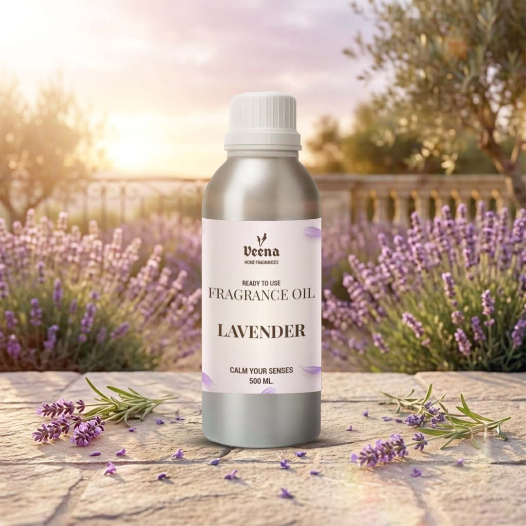 Veena Home Fragrances 500ml Lavender Fragrance Oil aluminum bottle on a stone surface surrounded by fresh lavender sprigs and a beautiful purple field background.