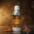 Veena Home Fragrances 500ml Saffron Tobacco Fragrance Oil aluminum bottle on a dark surface surrounded by dry tobacco leaves and golden saffron strands.