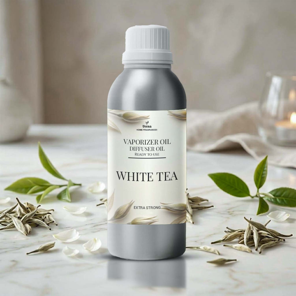 Veena White Tea Premium Vaporizer and Diffuser Oil silver aluminum bottle with botanical cream label on marble table with tea leaves