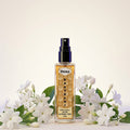 Veena Raat Rani Ultra Luxury Attar 8ml alcohol-free spray bottle centered between fresh white night-blooming jasmine flowers.