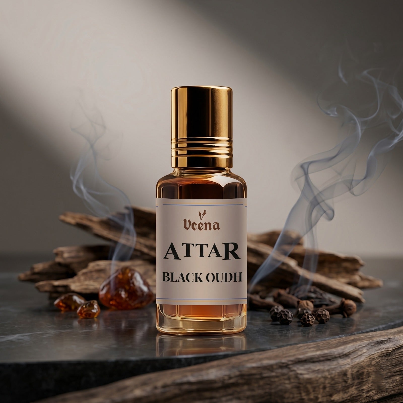 Veena Attar Black Oudh premium concentrated dark oud perfume oil bottle with a gold cap, set on a polished dark surface surrounded by natural agarwood pieces, raw amber resins, black peppercorns, and elegant curls of smoky incense.
