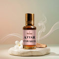 Veena Attar Fawakeh premium concentrated fruity perfume oil bottle with a gold cap, set on a smooth marble pedestal surrounded by a white flower blossom, natural wood pieces, and elegant curls of aromatic smoke.