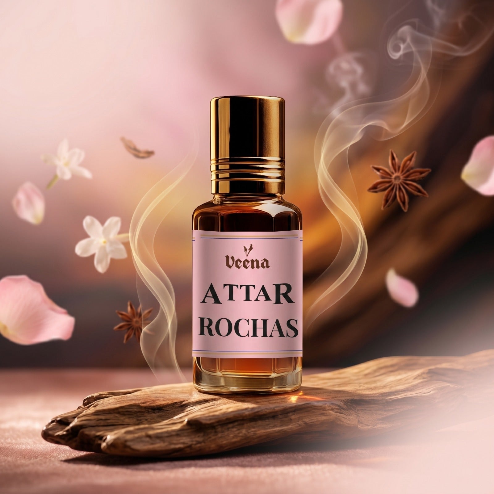 Veena Attar Rochas premium concentrated perfume oil bottle with a gold cap, set on a rustic piece of natural wood surrounded by floating pink petals, white flowers, star anise, and elegant curls of aromatic smoke.